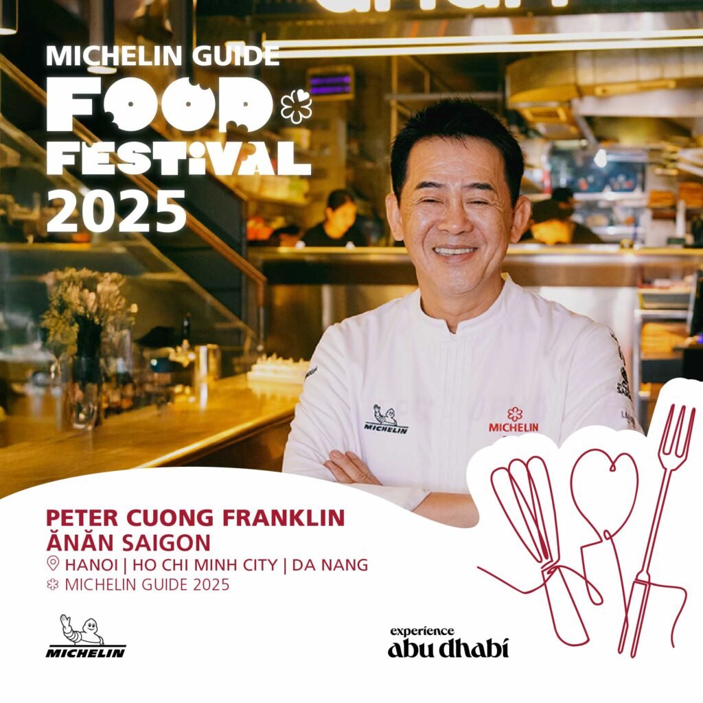 A chef wearing a white Michelin-branded jacket stands smiling in a professional kitchen. The image promotes the Michelin Guide Food Festival 2025, mentioning venues in Hanoi, Ho Chi Minh City, and Da Nang, along with the name "Peter Cuong Franklin" and "Ănăn Saigon." Branding includes the Michelin logo and "Experience Abu Dhabi." There is also a red line drawing of cooking utensils in the bottom right corner.