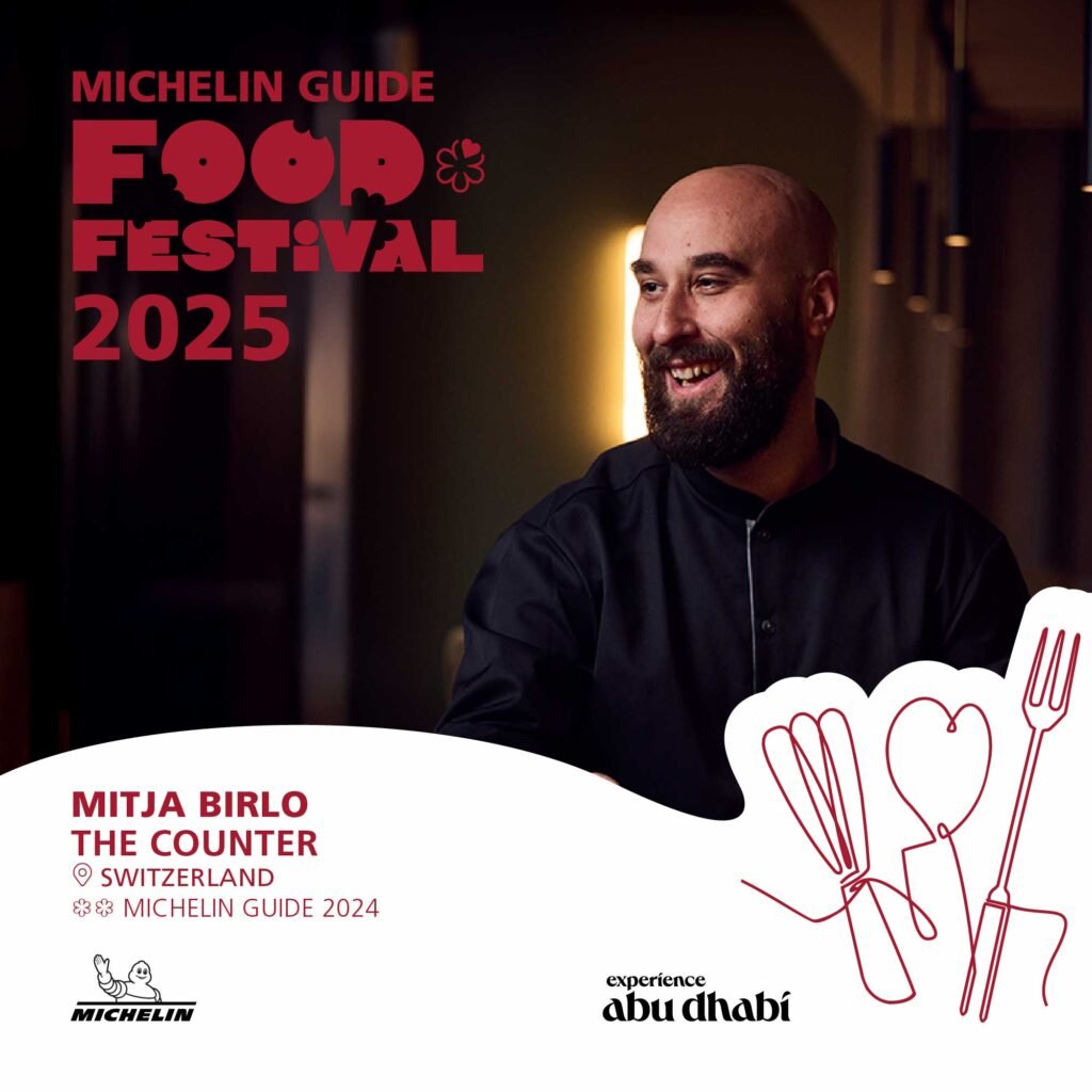 A promotional image for the Michelin Guide Food Festival 2025 featuring a smiling man with a beard and wearing a dark shirt. The text includes 'Mitja Birlo, The Counter, Switzerland' and 'Michelin Guide 2024.' The background includes stylized utensils and the 'experience abu dhabi' logo.