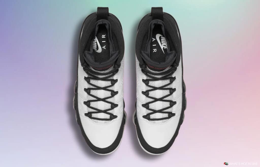 Top-down view of a pair of Air Jordan 9 Space Jam Nike Air sneakers with black laces on a gradient background.