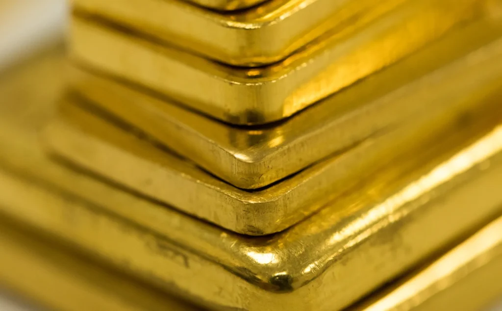 UAE Gold Price: Close-up of stacked gold bars with a shiny, reflective surface.