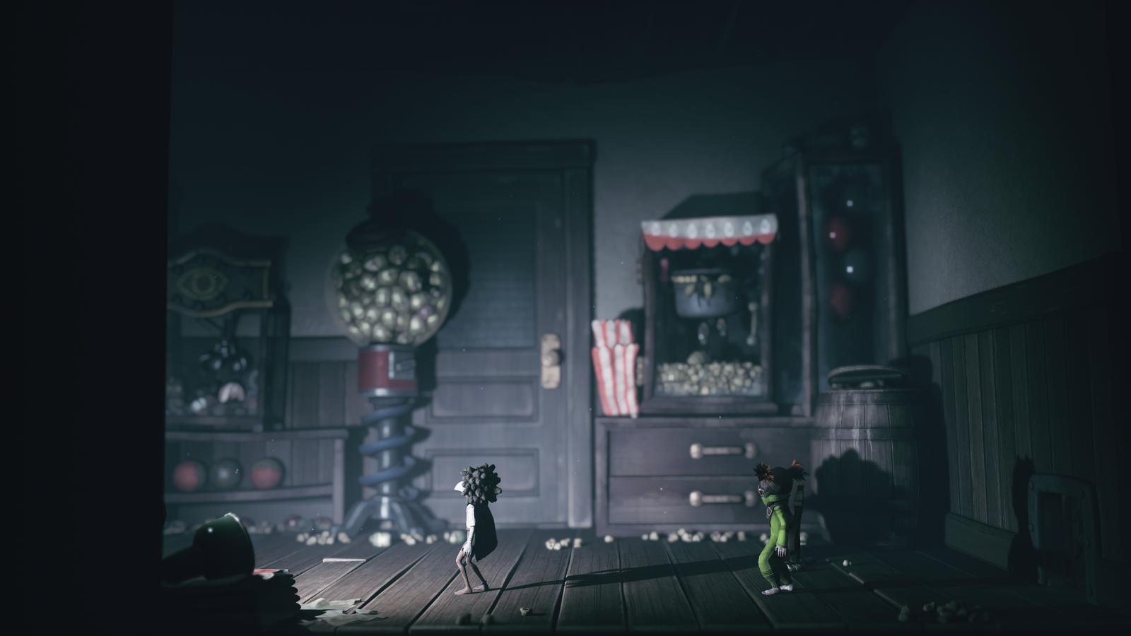 Two stylized, cartoonish characters stand in an eerie room with a gumball machine, wooden barrels, and dark, vintage furnishings. Little nightmares 3.