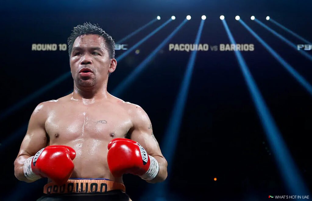 A boxer wearing red gloves and black shorts stands in a boxing ring under bright spotlights, with a scoreboard displaying "Round 10" and "Pacquiao vs Barrios" in the background.
