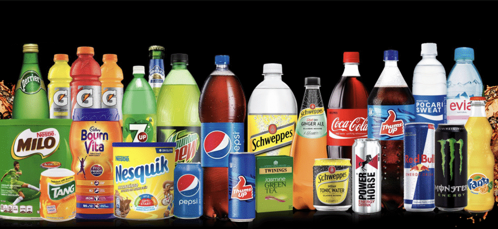 A variety of beverage products including Gatorade, Perrier, 7 Up, Mountain Dew, Pepsi, Schweppes, Coca-Cola, Pocari Sweat, Evian, Red Bull, Monster Energy, Fanta, Milo, Bournvita, Nesquik, Tang, and Thums Up, displayed against a black background.