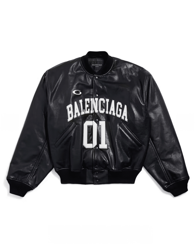 A black leather bomber jacket featuring the word "Balenciaga" and the number "01" printed in white on the front. Balenciaga Football Series