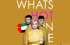Three people in yellow attire stand together with the text 'What's Hot In UAE' in large letters, set against a mustard yellow background with a UAE flag graphic on the left.
