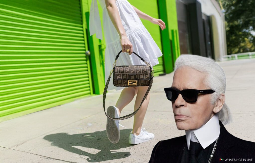 A person wearing a white dress and white sneakers is walking past a bright green garage door, holding a designer handbag. In the bottom right corner, an image of a person with white hair and sunglasses is overlaid.