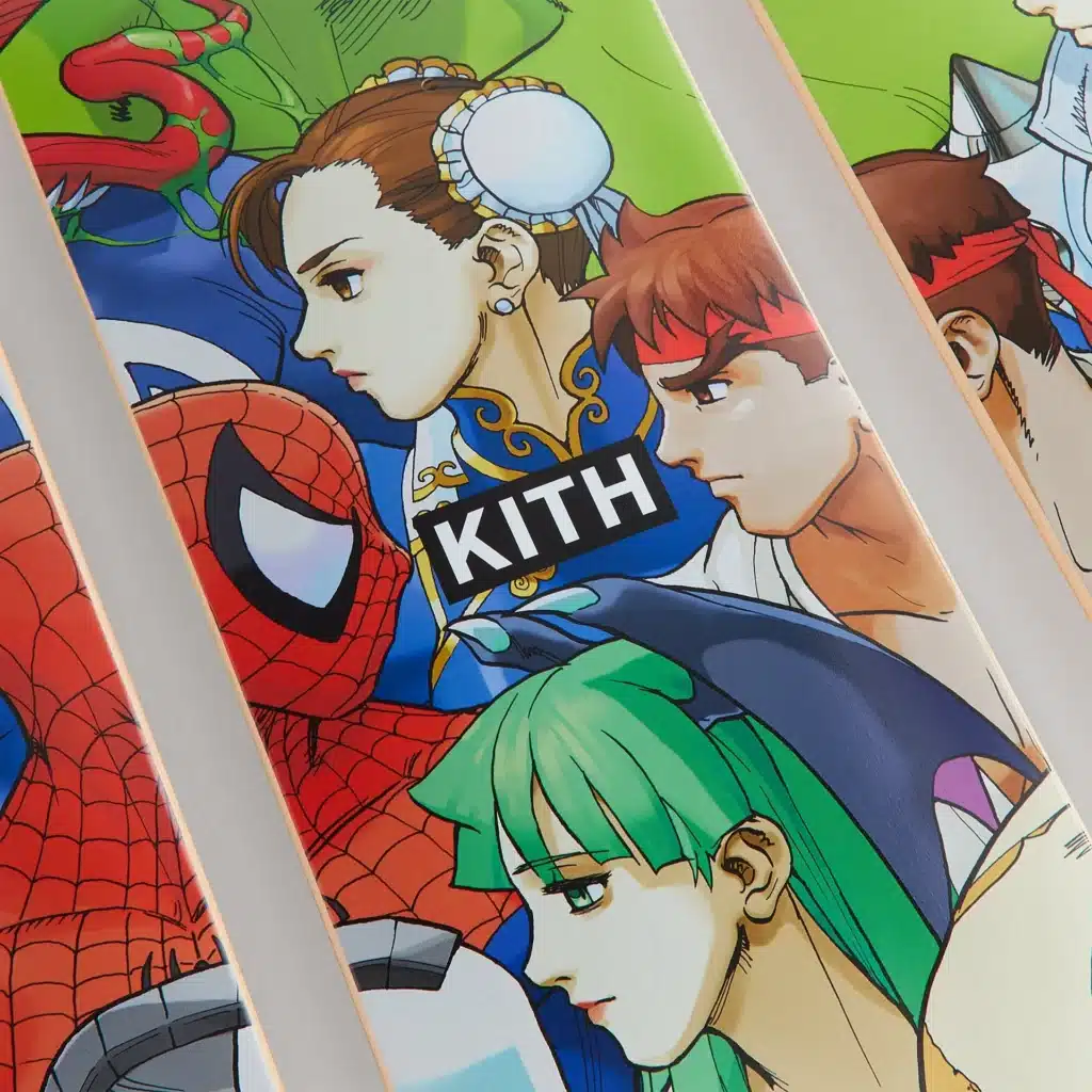 A skateboard deck featuring comic and video game characters, including a red and blue costumed hero, a woman with traditional hair buns and a blue outfit, and other animated figures. The brand name 'KITH' is prominently displayed in black on a white background.