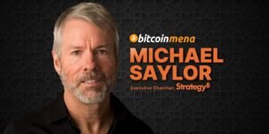 Close-up of a man with gray hair and a beard, wearing a black shirt, with the text "bitcoin mena, Michael Saylor, Executive Chairman, STrategy" on a patterned dark background.