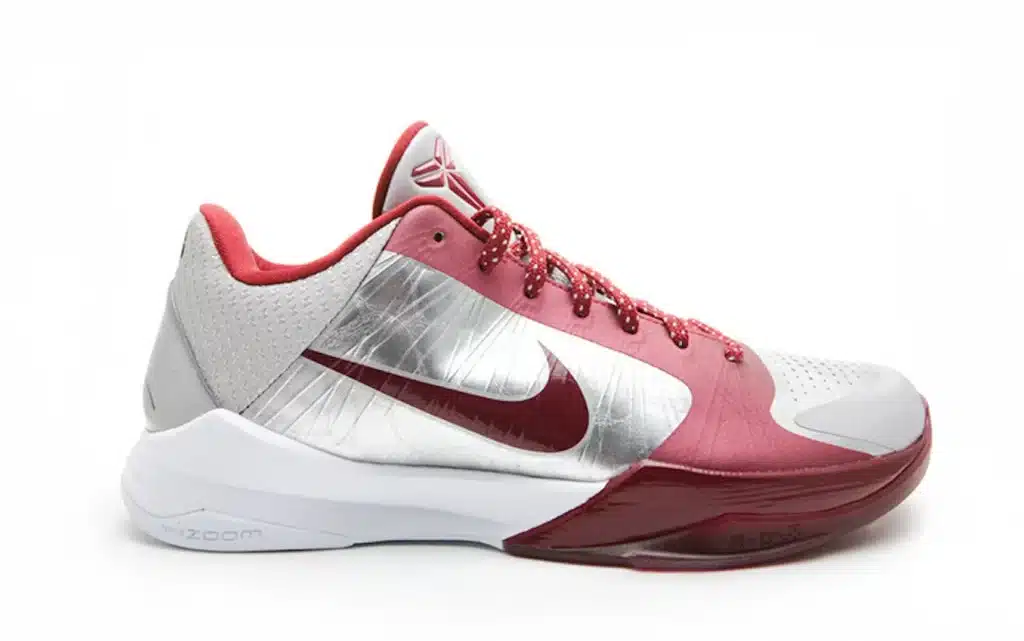 Nike Kobe 5 Protro 'Lower Merion Aces' with a metallic Nike swoosh logo on the side and red laces, featuring a thick white sole marked with 'NIKE ZOOM'.