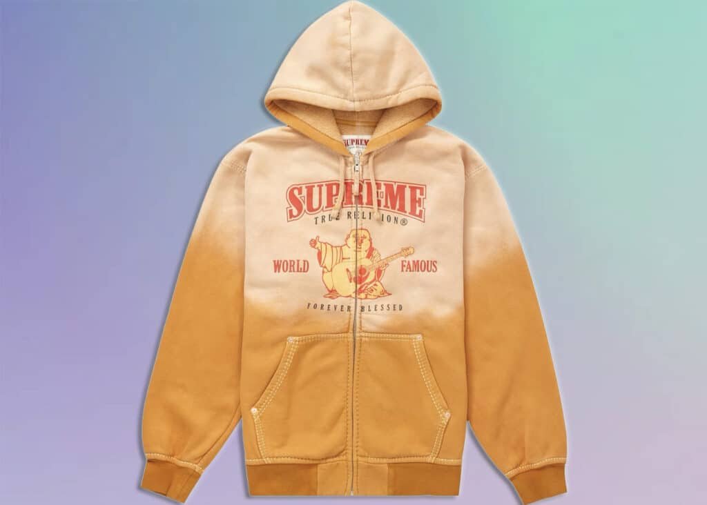 A tan ombré hoodie with the words "Supreme x True Religion" printed in red, along with a graphic of a figure playing a guitar and the phrases "WORLD FAMOUS" and "FOREVER BLESSED."