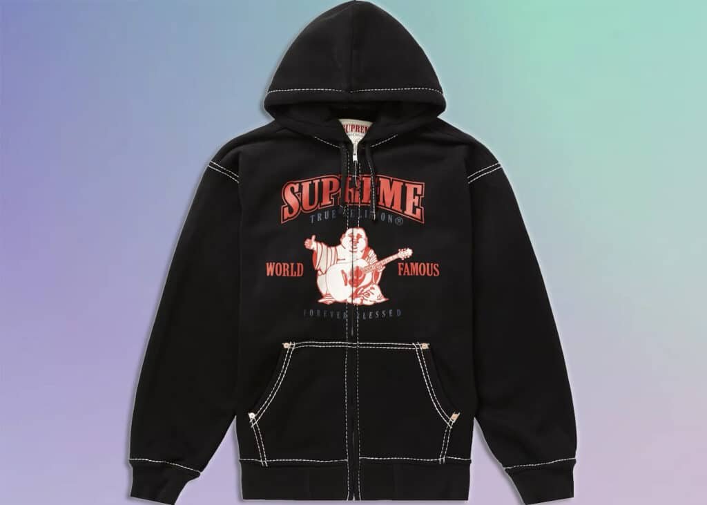 Black hooded sweatshirt featuring a graphic design with the word 'SUPREME' in red letters, an illustration of a figure holding a guitar, and the words 'WORLD FAMOUS' and 'FOREVER BLESSED'.