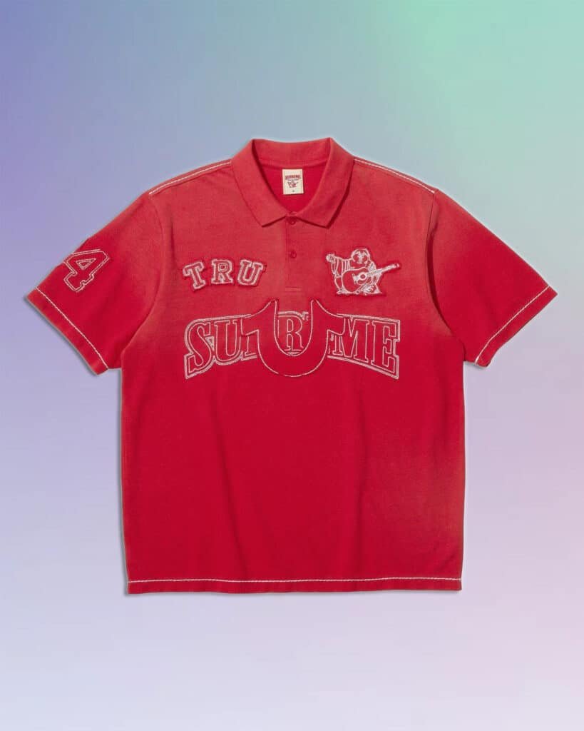 A red polo shirt with "TRU SUPREME" and a bear playing guitar embroidered on the front, featuring white stitching details and the number 44 on the sleeve, set against a gradient blue to purple background.