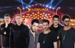A group of six men standing in front of a stage with bright lights and the word 'Ushuaïa' displayed prominently, suggesting a music festival or concert venue.