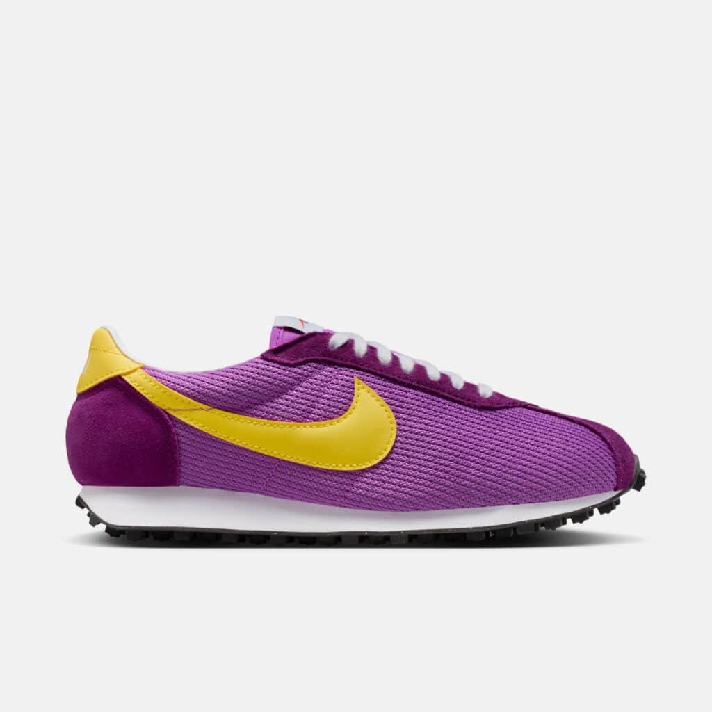 A purple and yellow sneaker with a mesh upper and a prominent yellow swoosh logo on the side, set against a plain white background.