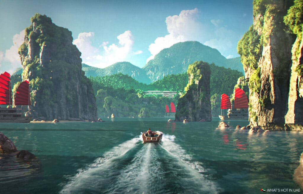 A scenic view of a man riding a speedboat through a clear green-blue lagoon, surrounded by towering limestone cliffs with lush greenery. Traditional boats with red sails are seen in the background under a blue sky with white clouds.