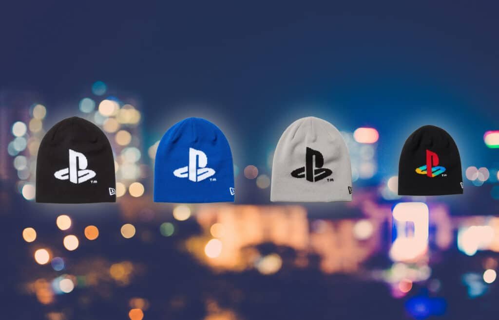 Four beanies with different PlayStation logo designs against a blurred city lights background.
