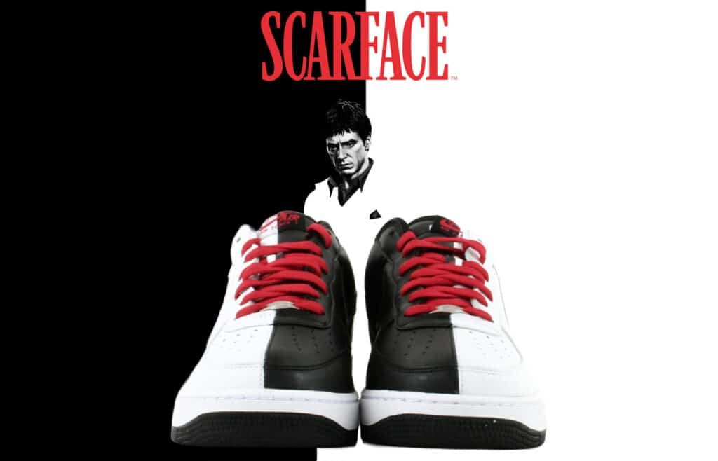 Black and white sneakers with red laces, set against a split background with "Scarface" text and a movie character image.