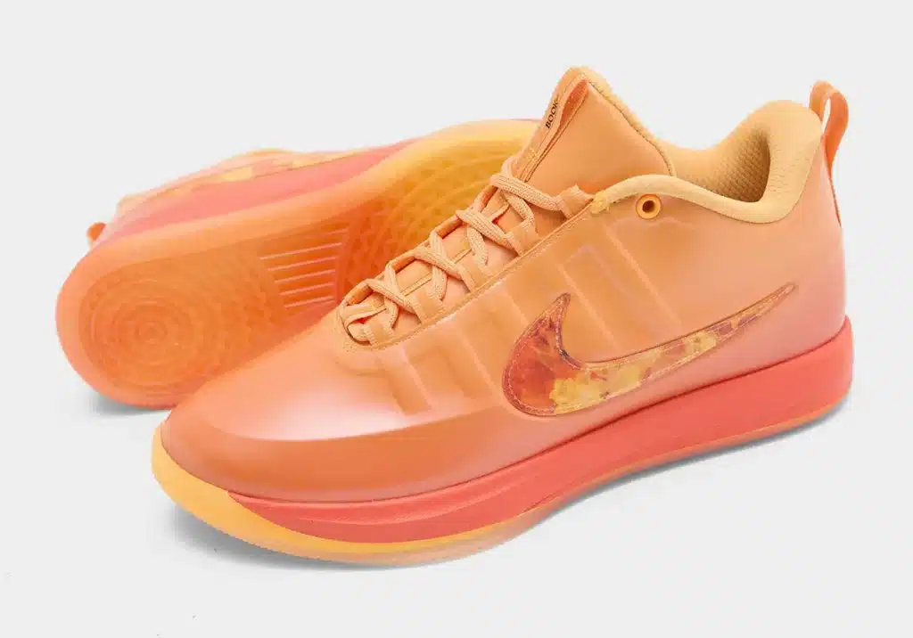 Orange Nike Book 2 Phoenix sneakers with a matching swoosh logo featuring a fiery pattern, shown from the side and bottom.