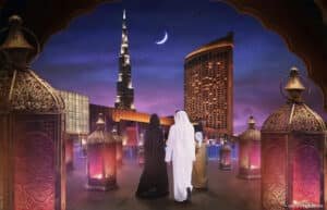 A group of people in traditional attire walk towards a lit-up cityscape, featuring a crescent moon and the Burj Khalifa in the background.