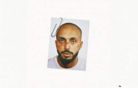 A photo of a man with a neutral expression, clipped to a white background.