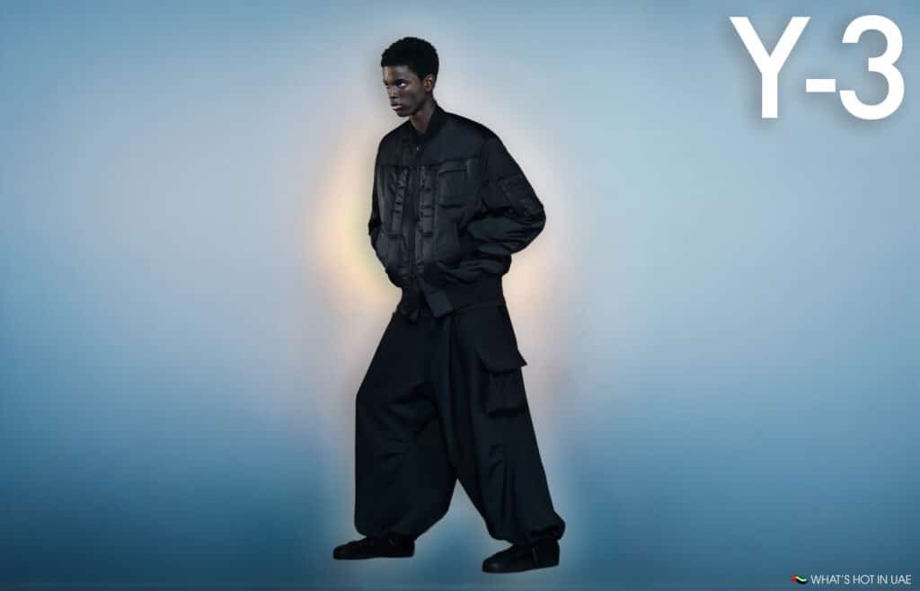 A model in dark, loose-fitting clothing poses against a gradient blue background, with the letters 'Y-3' in the upper-right corner.