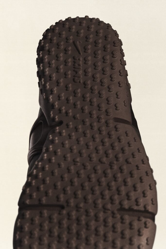The bottom sole of a shoe with a textured, dotted pattern and "NIKE" engraved.