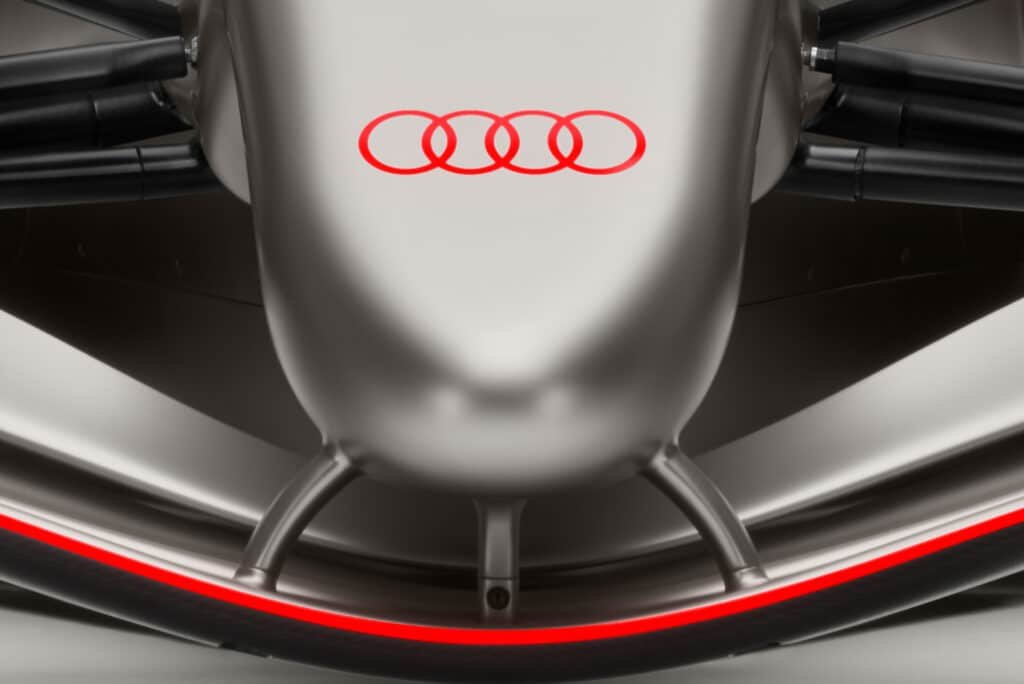 Front view of a sleek, futuristic car with a metallic finish and the Audi logo prominently displayed.