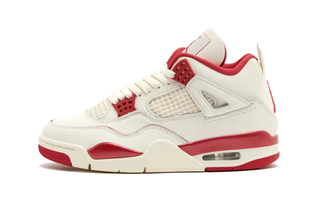 White and red Air Jordan 4 "Valentine's Day" sneaker with mesh panels and visible air cushioning in the sole.
