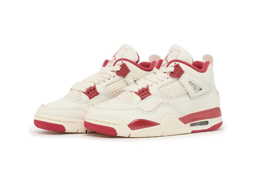 White and red Air Jordan 4 "Valentine's Day" sneakers with mesh panels, visible air cushioning, and lace-up design.