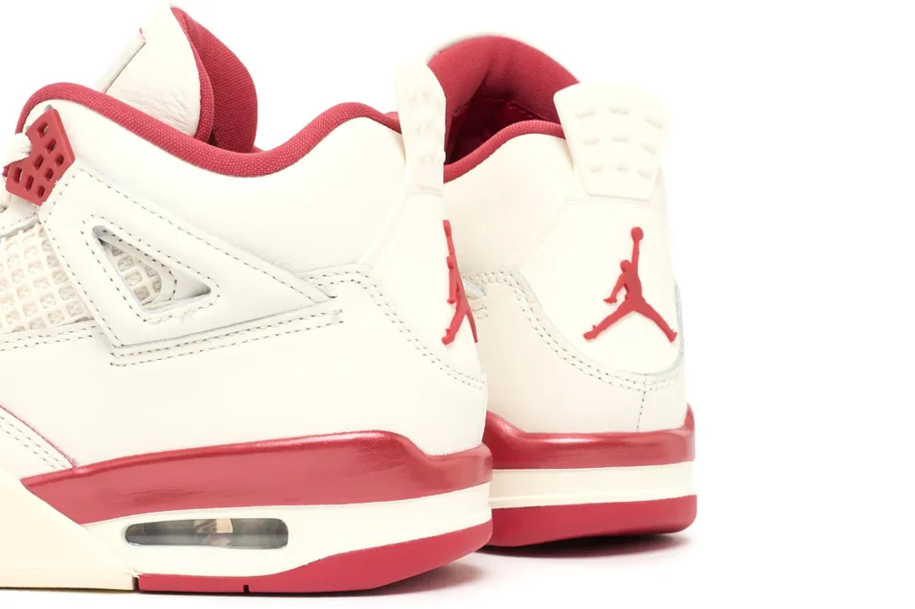 White and red Air Jordan 4 "Valentine's Day" with a visible Air unit and a red jumpman logo on the heel.