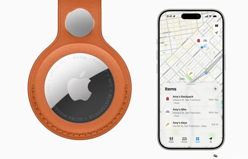 An Apple AirTag in an orange leather holder next to a smartphone displaying a map and item tracking details.