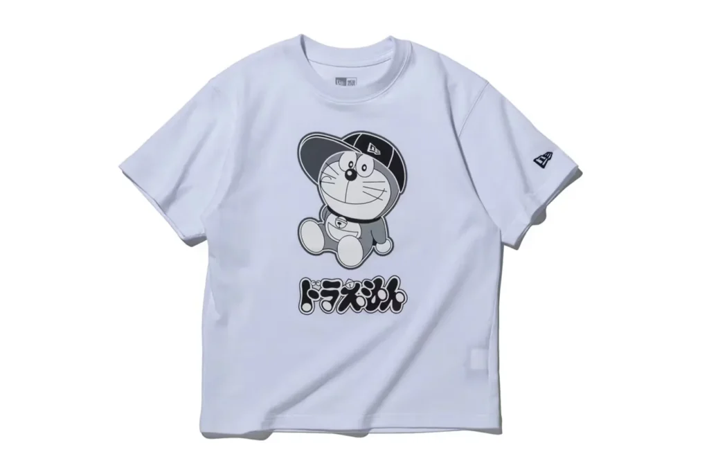 A white T-shirt featuring an animated character wearing a cap, with Japanese text below the image.