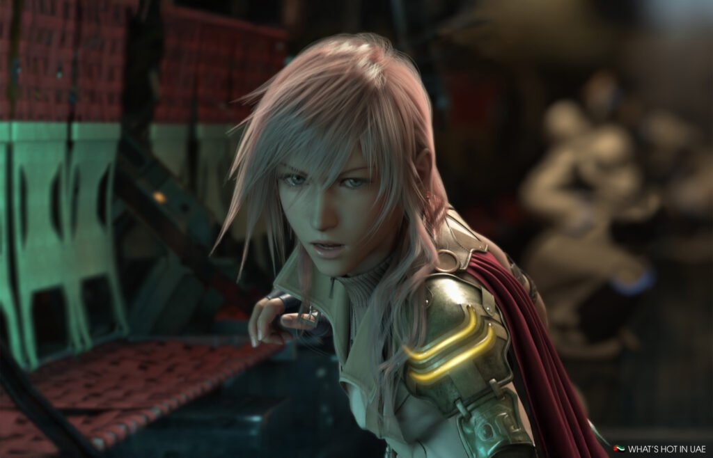 A Final Fantasy 13 PS5 character with long silver hair and armor looks intently forward; a red cape is draped over her shoulder.