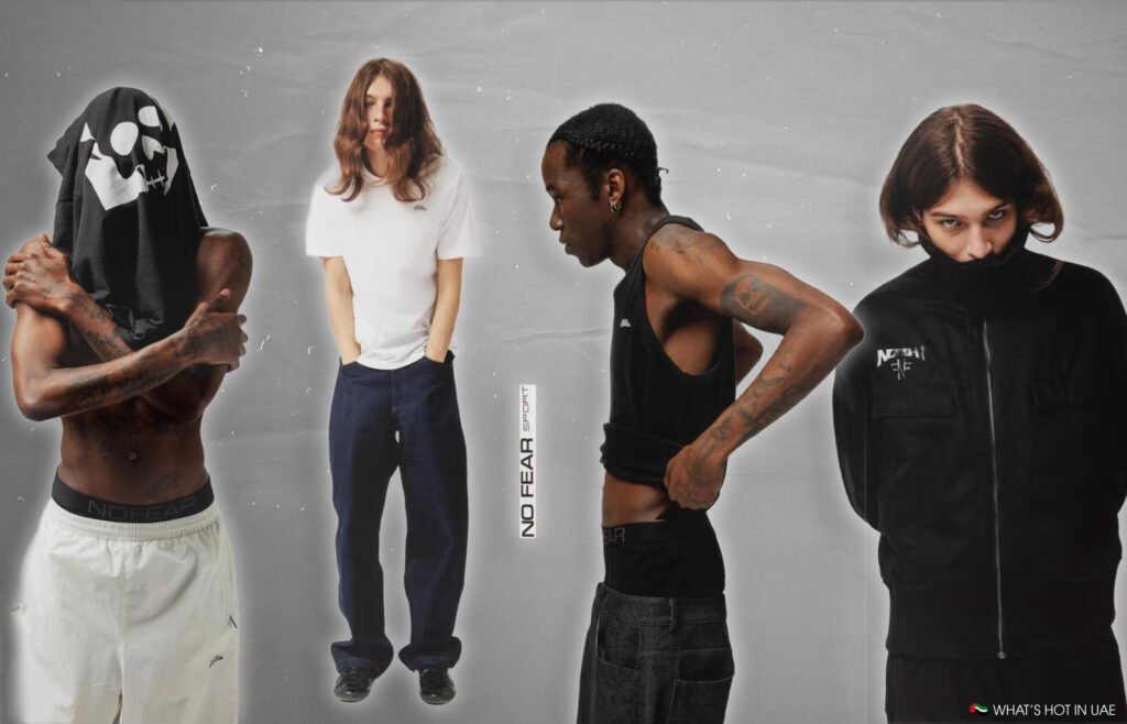 Four young men in different outfits, including casual and streetwear, with one wearing a t-shirt over his head.