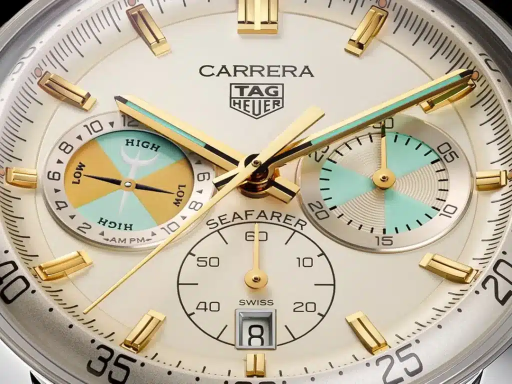 Close-up of a Tag Heuer Carrera Seafarer watch with gold accents, showcasing a unique dial with vintage-style subdials and a date display.