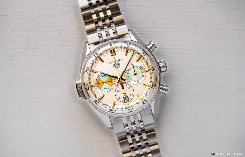 A luxury wristwatch with a stainless steel band and a beige dial featuring multiple subdials and hour markers.