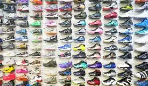A wall display of colorful athletic shoes arranged neatly in rows.