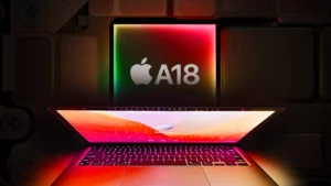 A laptop with a glowing screen below a large, illuminated sign displaying "A18" and an apple logo.