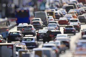 Heavy traffic with cars and buses on a busy road in daylight.