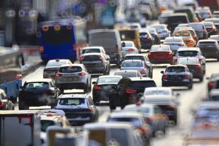 Heavy traffic with cars and buses on a busy road in daylight.