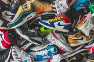 A pile of colorful sneakers with various designs and logos.