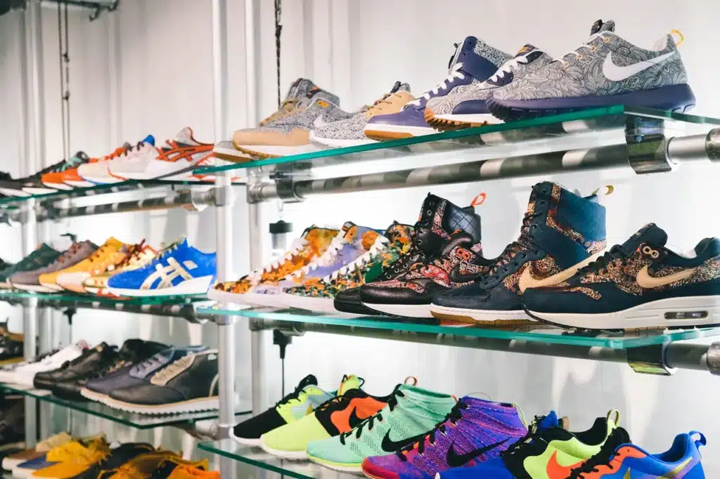 Rows of colorful sneakers displayed on metal shelves, featuring various designs and patterns.