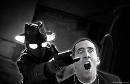 A mysterious figure in a hat and trench coat points forward, while a surprised man appears in the background.