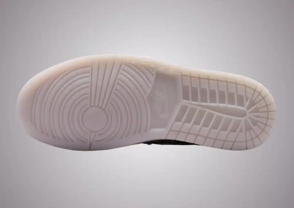 The sole of a Swarovski x Air Jordan 1 sneaker featuring a circular tread pattern and the Nike logo.