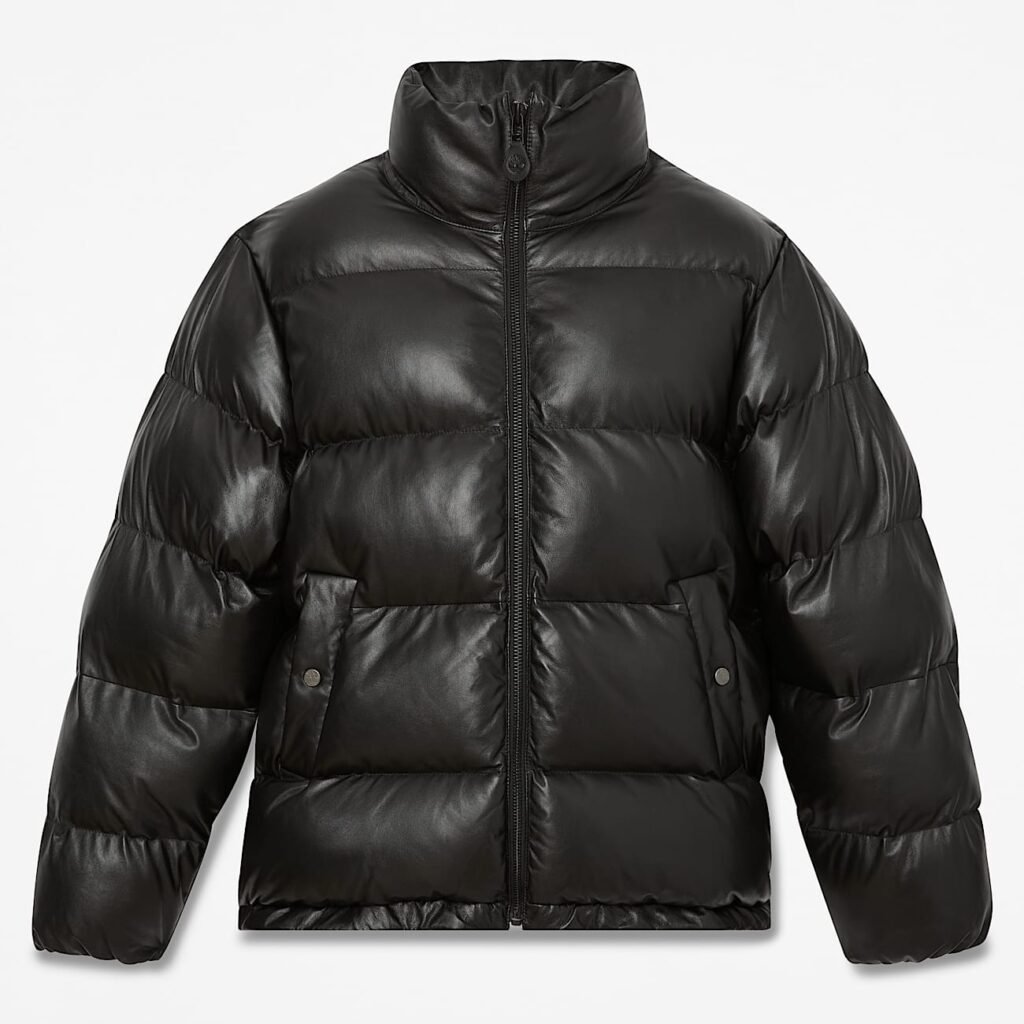 A black Timberland Welch Mountain Leather Puffer jacket with a high collar and front zipper, featuring large quilted sections and two front pockets.