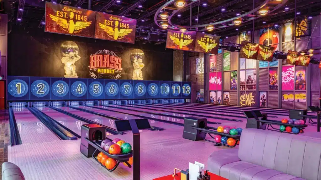 Colorful Dubai bowling center with numbered lanes, vibrant lighting, and themed wall decorations.