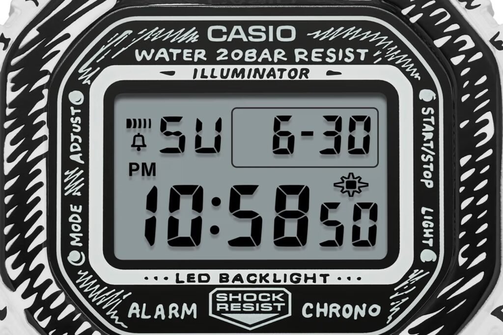 G-SHOCK x Joshua Vides Digital watch display showing 10:58:50 PM, with the date set to Sunday, June 30, and various function labels.
