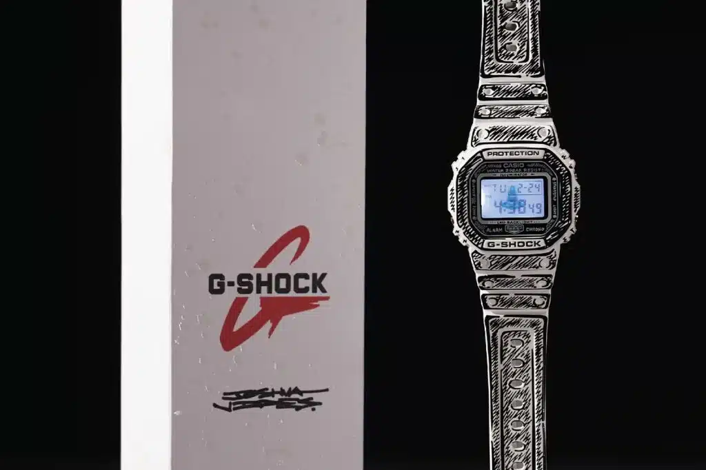 A patterned G-Shock watch with a digital display next to branded packaging with logo.