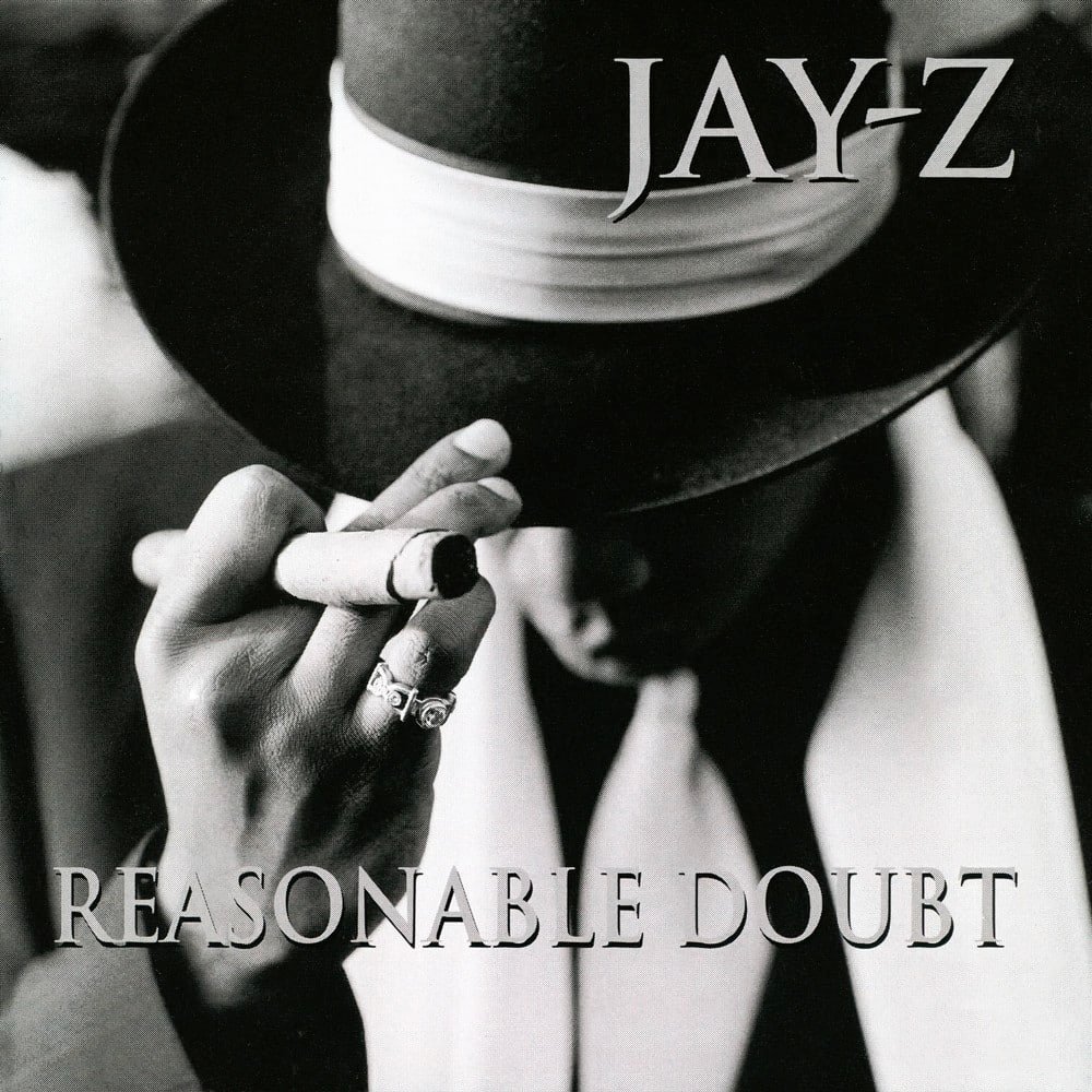 A man in a suit and fedora holding a cigar with the text "JAY-Z" and "Reasonable Doubt" on the cover.