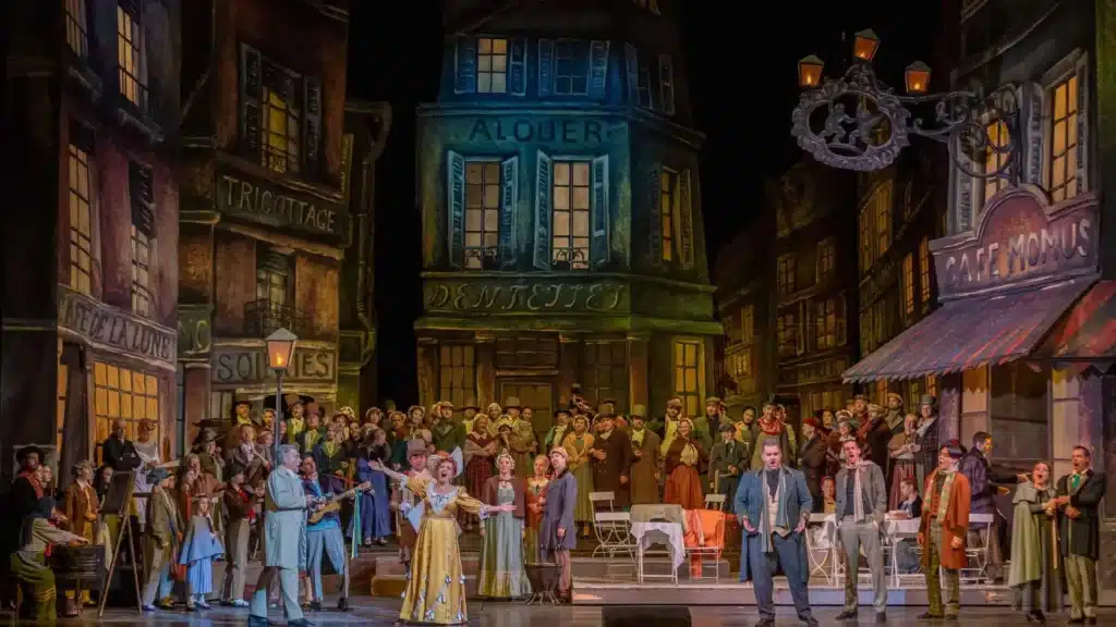 A vibrant opera performance set in a lively street scene with singers dressed in period costumes and a backdrop of vintage buildings.